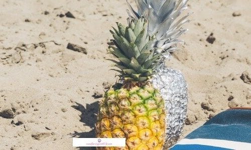 Self care routine for the summer has to include fruit like pineapple and a bag with sun protection products